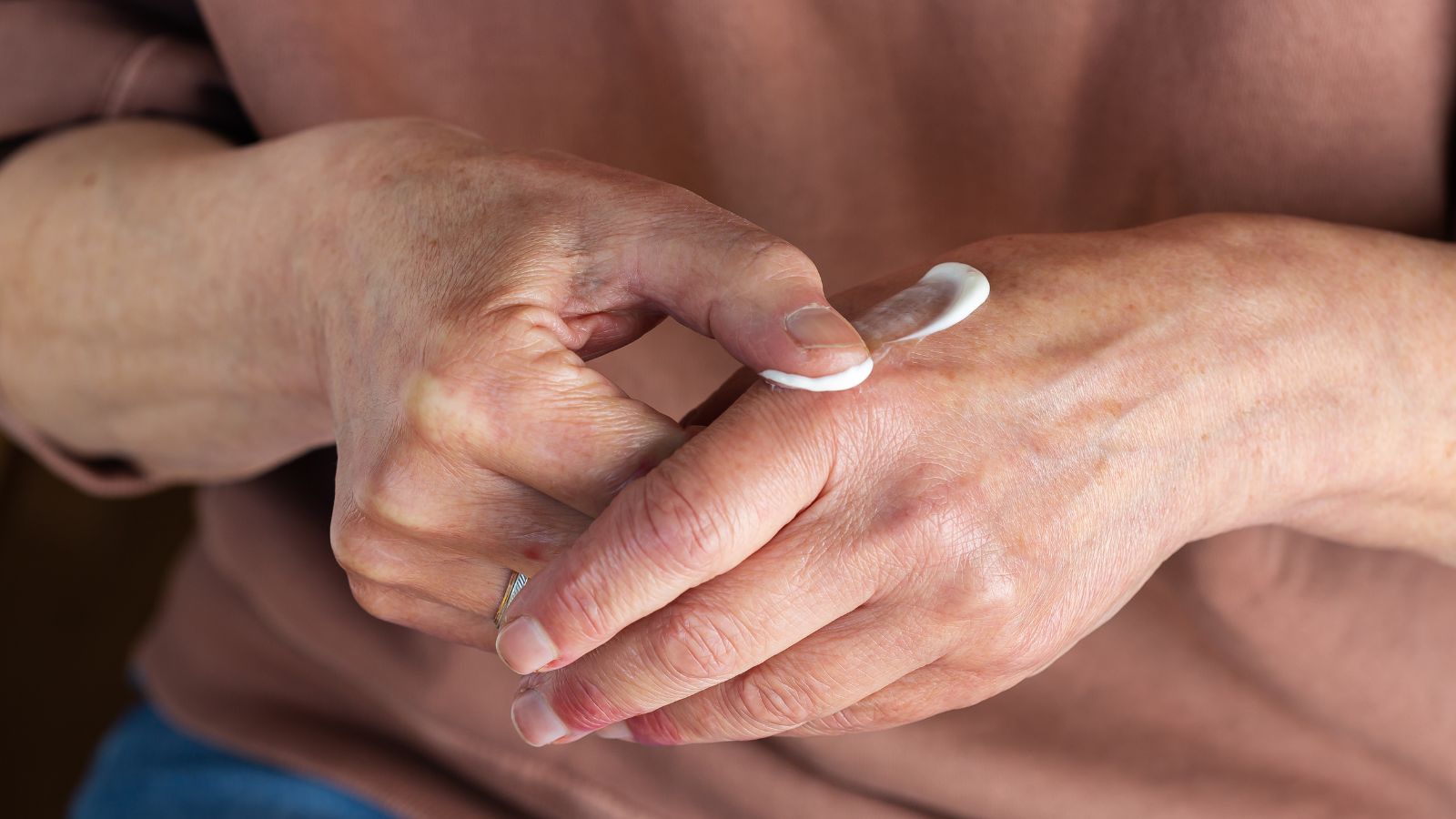 Person applying greenway biotech magnesium cream to palm of hand
