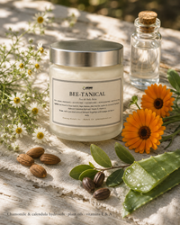 Bee-Tanical balm jar with fresh chamomile, calendula, aloe and almonds on a garden table