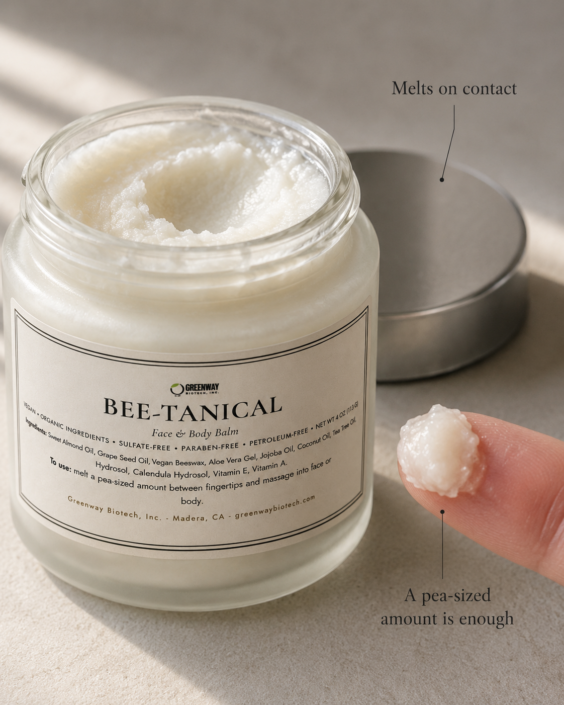 Close-up of Bee-Tanical balm's whipped texture with a pea-sized amount melting on a fingertip