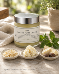 Solene Foot Cream jar with raw carnauba wax, shea butter and cocoa butter on linen