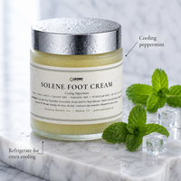 Chilled Solene peppermint foot cream jar on marble with mint sprigs and ice, labeled refrigerate for extra cooling